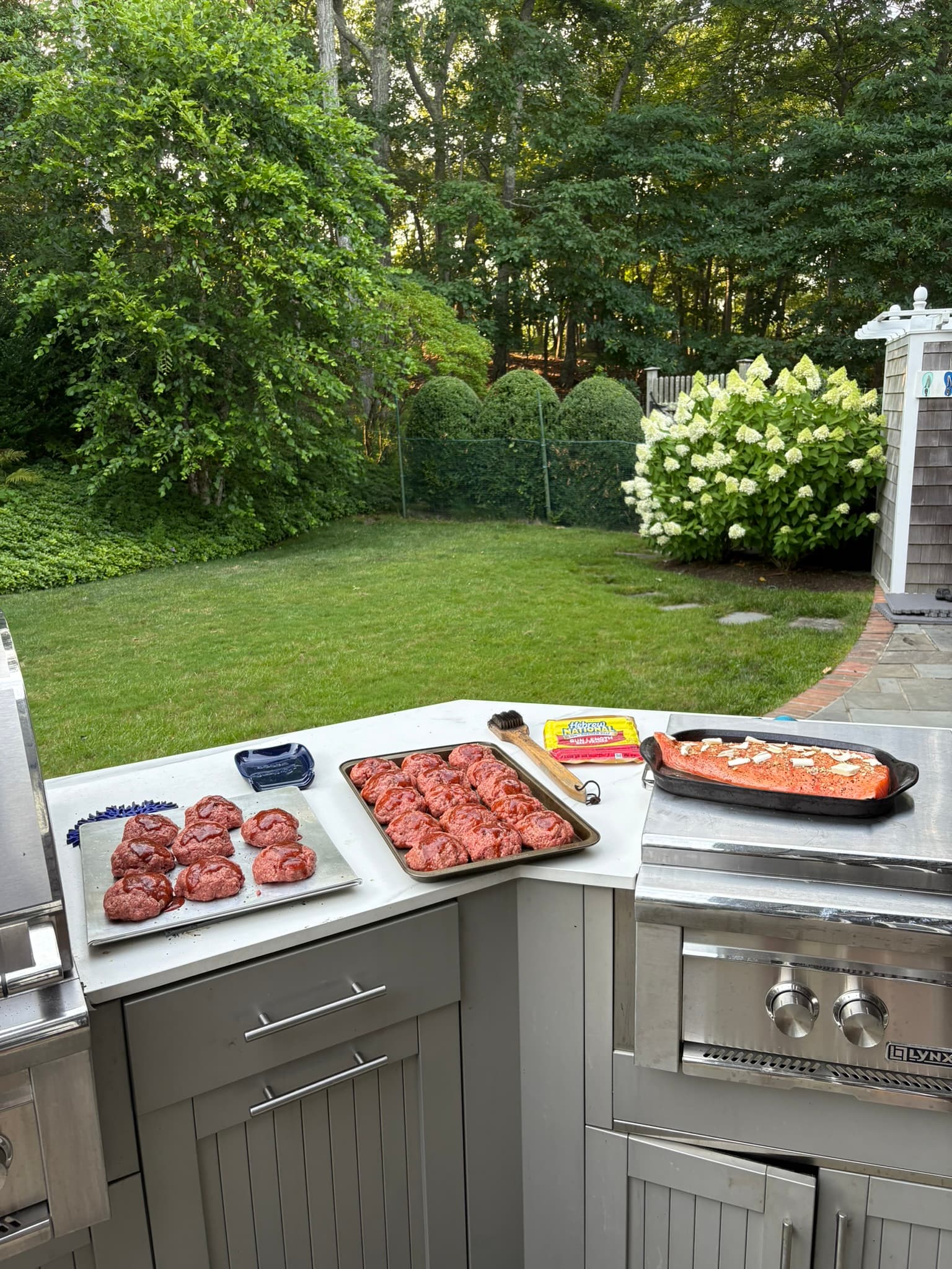 Outdoor prep with salmon and burgers ready for the grill